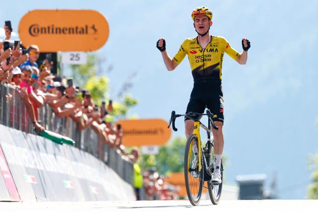 Team Visma Lease a Bike US rider Sepp Kuss celebrates as he crosses the finish line to win the 19th stage of the Giro d'Italia 2026 - Tour of Italy cycling race between Feltre and Alleghe, Italy, on May 29, 2026. (Photo by Luca Bettini / AFP)