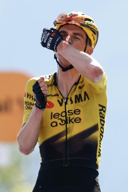 Team Visma Lease a Bike US rider Sepp Kuss celebrates as he crosses the finish line to win the 19th stage of the Giro d'Italia 2026 - Tour of Italy cycling race between Feltre and Alleghe, Italy, on May 29, 2026. (Photo by Luca Bettini / AFP)