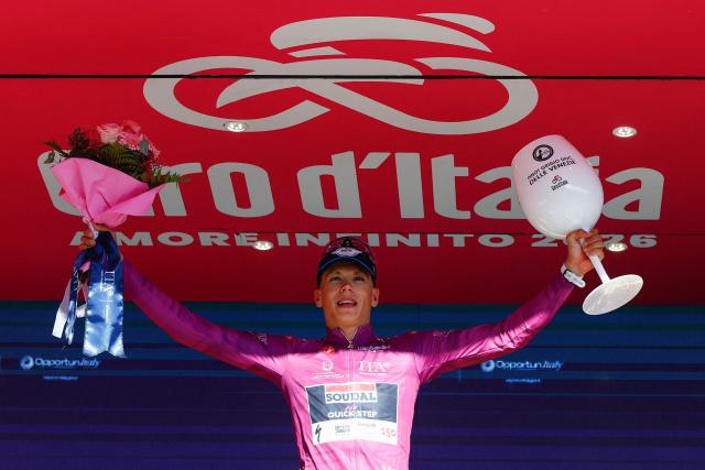 Soudal Quick-Step French rider Paul Magnier celebrates on the podium with the best sprinter's purple jersey after the 19th stage of the Giro d'Italia 2026 - Tour of Italy cycling race between Feltre and Alleghe, Italy, on May 29, 2026. (Photo by Luca Bettini / AFP)