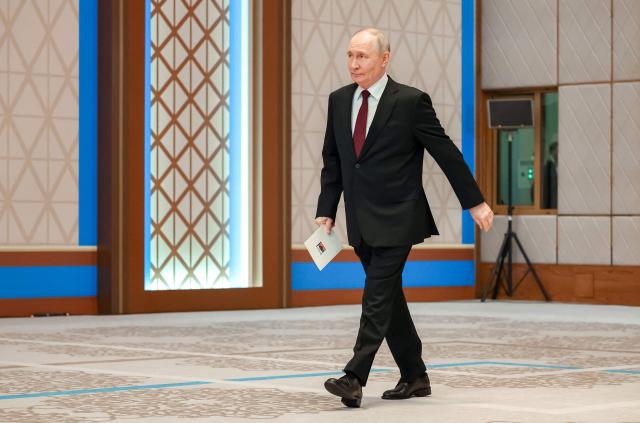 In this pool photograph distributed by the Russian state agency Sputnik Russia's President Vladimir Putin arrives to address a press-conference during his state visit to Kazakhstan at the Palace of Independence in Astana on May 29, 2026. (Photo by Alexander KAZAKOV / POOL / AFP)
