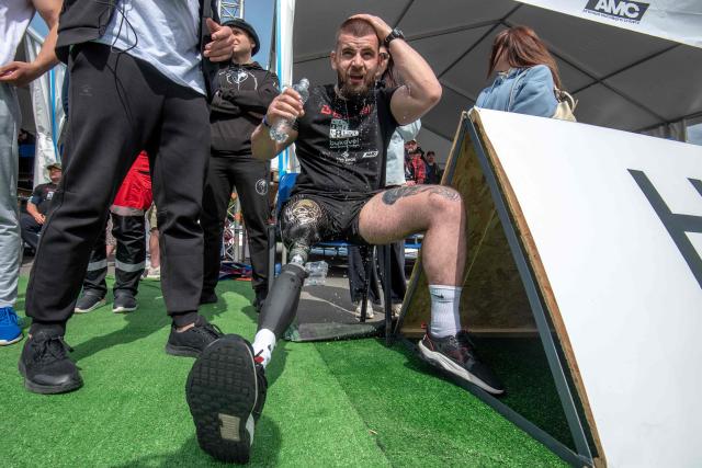 A Ukrainian veteran douses himself with water as he competes in the Multisport Festival for Veterans in Bukovel, south-western Ukraine on May 29, 2026, amid the Russian invasion of Ukraine. Competitions are held in individual and team formats, combining strength, functional and adaptive elements to allow participants to demonstrate their abilities. The events are designed for war veterans, taking into account varying levels of physical fitness, recovery needs, service experience and rehabilitation requirements. (Photo by Mykola SYNELNYKOV / AFP)