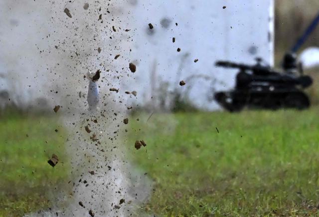Smoke billows after a GADCI grenade is launched from a drone during a demonstration at Indumil (Military Industry) Santa Barbara factory in Sogamoso, Boyaca department, Colombia, on May 28, 2026. A military drone fitted with a grenade launcher breaks the silence of the Andes. Hovering in the air, it locks onto a target and drops a payload of TNT that reverberates through the mountains. This is how Colombia has entered the drone war to combat the guerrillas. (Photo by Raul ARBOLEDA / AFP)
