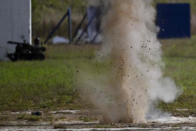 Smoke billows after a GADCI grenade is launched from a drone during a demonstration at Indumil (Military Industry) Santa Barbara factory in Sogamoso, Boyaca department, Colombia, on May 28, 2026. A military drone fitted with a grenade launcher breaks the silence of the Andes. Hovering in the air, it locks onto a target and drops a payload of TNT that reverberates through the mountains. This is how Colombia has entered the drone war to combat the guerrillas. (Photo by Raul ARBOLEDA / AFP)