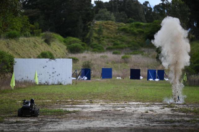 Smoke billows after a GADCI grenade is launched from a drone during a demonstration at Indumil (Military Industry) Santa Barbara factory in Sogamoso, Boyaca department, Colombia, on May 28, 2026. A military drone fitted with a grenade launcher breaks the silence of the Andes. Hovering in the air, it locks onto a target and drops a payload of TNT that reverberates through the mountains. This is how Colombia has entered the drone war to combat the guerrillas. (Photo by Raul ARBOLEDA / AFP)