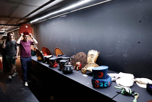 Customers browse through items for sale during a costume sale held by the Bastille Opera in Paris on May 29, 2026. The Opera Bastille is putting around 5,000 costumes for sale. (Photo by Kenzo TRIBOUILLARD / AFP)