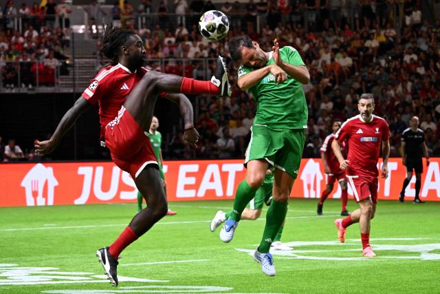 Swiss former footballer Johan Djourou (L) and Hungarian former footballer Nemanja Nikolic vie for the ball during the final football match of the Ultimate Champions Legends Tournament at the Papp Laszlo Arena in Budapest on May 29, 2026, on the eve of the UEFA Champions League final. (Photo by Attila KISBENEDEK / AFP)