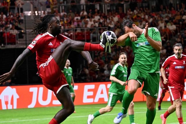 Swiss former footballer Johan Djourou (L) and Hungarian former footballer Nemanja Nikolic vie for the ball during the final football match of the Ultimate Champions Legends Tournament at the Papp Laszlo Arena in Budapest on May 29, 2026, on the eve of the UEFA Champions League final. (Photo by Attila KISBENEDEK / AFP)