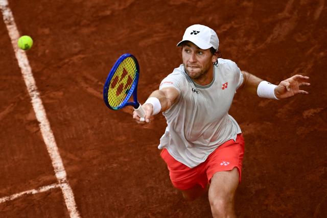 Norway's Casper Ruud plays a backhand return to US Tommy Paul during their men's singles match on day 6 of the French Open tennis tournament on Court Suzanne-Lenglen at the Roland-Garros Complex in Paris on May 29, 2026. (Photo by JULIEN DE ROSA / AFP)
