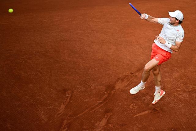 Norway's Casper Ruud plays a forehand return to US Tommy Paul during their men's singles match on day 6 of the French Open tennis tournament on Court Suzanne-Lenglen at the Roland-Garros Complex in Paris on May 29, 2026. (Photo by JULIEN DE ROSA / AFP)