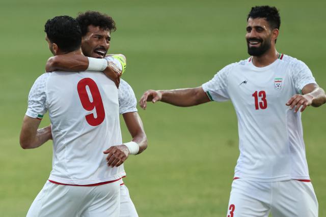 Iran's Forward #23 Ramin Rezaeian celebrates with teammates after scoring their side's second goal during an international friendly football match between Iran and Gambia, in Antalya, southern Turkey, May 29, 2026, as part of Iran's preparation for the upcoming football World Cup. (Photo by Oner SAN / AFP)