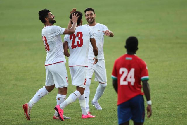 Iran's Forward #23 Ramin Rezaeian celebrates with teammates after scoring their side's second goal during an international friendly football match between Iran and Gambia, in Antalya, southern Turkey, May 29, 2026, as part of Iran's preparation for the upcoming football World Cup. (Photo by Oner SAN / AFP)