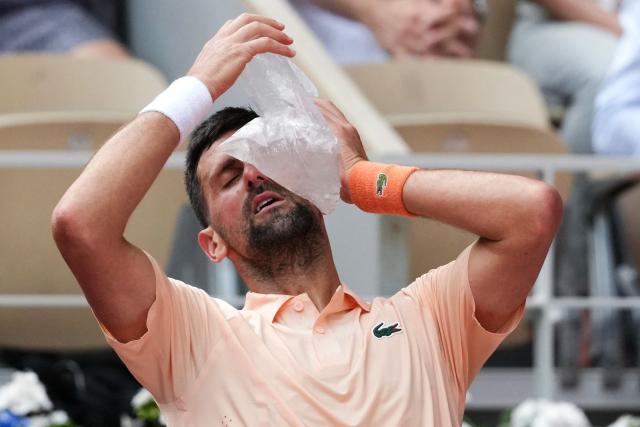 Serbia's Novak Djokovic tries to cool off while sitting in between games as he plays against Brazil's Joao Fonseca during their men's singles match on day 6 of the French Open tennis tournament on Court Philippe-Chatrier at the Roland-Garros Complex in Paris on May 29, 2026. (Photo by Dimitar DILKOFF / AFP)