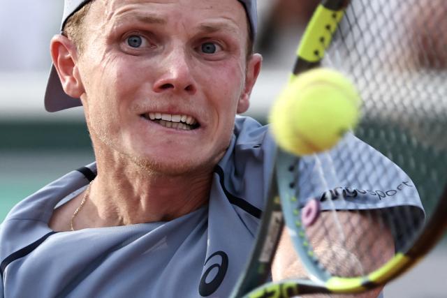 Netherlands' Jesper de Jong plays a backhand return to Karen Khachanov during their men's singles match on day 6 of the French Open tennis tournament at the Roland-Garros Complex in Paris on May 29, 2026. (Photo by Anne-Christine POUJOULAT / AFP)