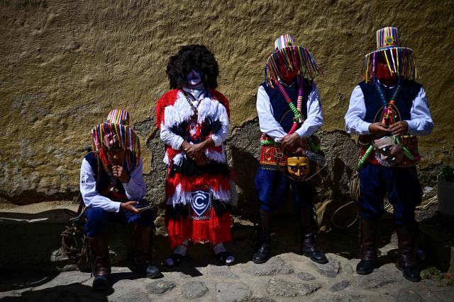 Members of a dance troupe take part in the Lord of Choquekillka festival in Ollantaytambo, in the Cusco region of southern Peru, on May 24, 2026. The Lord of Choquekillka is the patron saint of Ollantaytambo, in the Cusco region, and the focus of a religious and cultural festival declared National Cultural Heritage. The main celebrations take place during Pentecost in May, blending Catholic devotion with ancestral dances, traditional music and Andean spiritual traditions. (Photo by ERNESTO BENAVIDES / AFP)