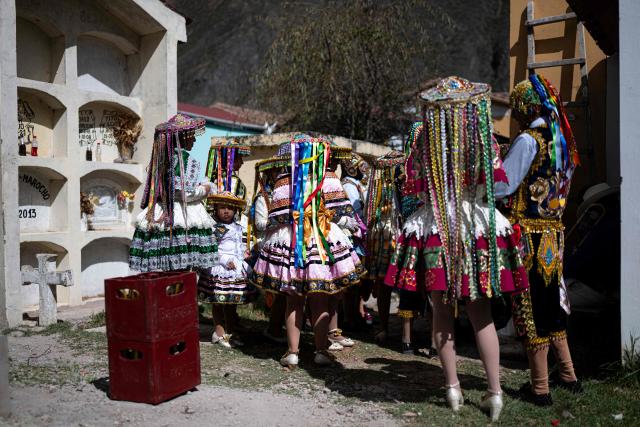 Members of a dance troupe take part in the Lord of Choquekillka festival in Ollantaytambo, in the Cusco region of southern Peru, on May 25, 2026. The Lord of Choquekillka is the patron saint of Ollantaytambo, in the Cusco region, and the focus of a religious and cultural festival declared National Cultural Heritage. The main celebrations take place during Pentecost in May, blending Catholic devotion with ancestral dances, traditional music and Andean spiritual traditions. (Photo by ERNESTO BENAVIDES / AFP)