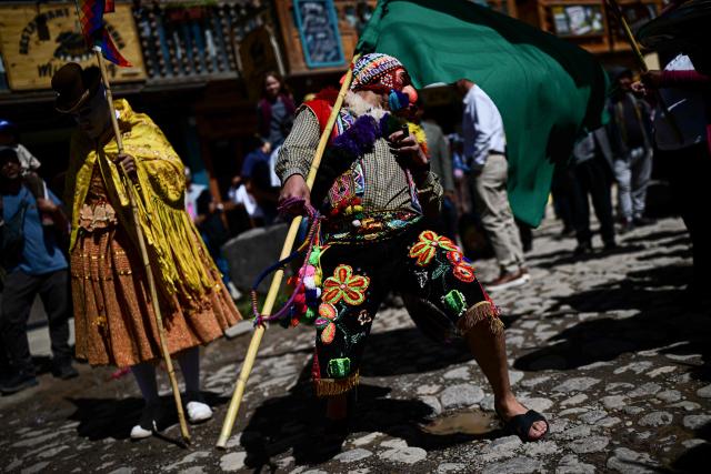 A dancer performs during the Lord of Choquekillka festival in Ollantaytambo, in the Cusco region of southern Peru, on May 24, 2026. The Lord of Choquekillka is the patron saint of Ollantaytambo, in the Cusco region, and the focus of a religious and cultural festival declared National Cultural Heritage. The main celebrations take place during Pentecost in May, blending Catholic devotion with ancestral dances, traditional music and Andean spiritual traditions. (Photo by ERNESTO BENAVIDES / AFP)