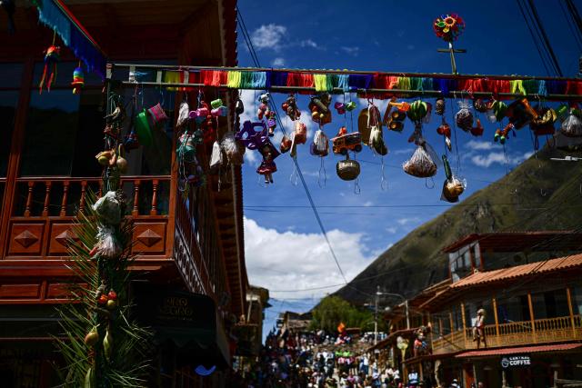 Decorations hang during the Lord of Choquekillka festival in Ollantaytambo, in the Cusco region of southern Peru, on May 24, 2026. The Lord of Choquekillka is the patron saint of Ollantaytambo, in the Cusco region, and the focus of a religious and cultural festival declared National Cultural Heritage. The main celebrations take place during Pentecost in May, blending Catholic devotion with ancestral dances, traditional music and Andean spiritual traditions. (Photo by ERNESTO BENAVIDES / AFP)