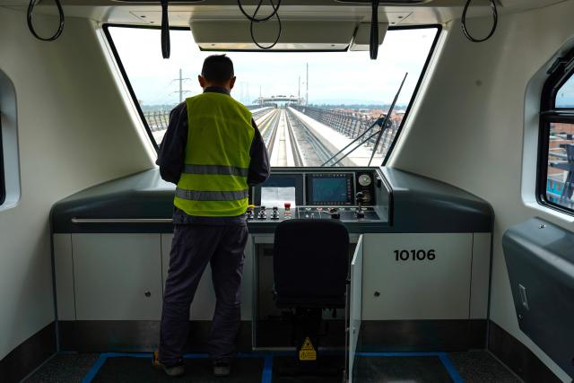 A train driver operates a train during a test run on the first line of the Bogota Metro in Bogota on May 29, 2026. (Photo by Sergio Acero / AFP)