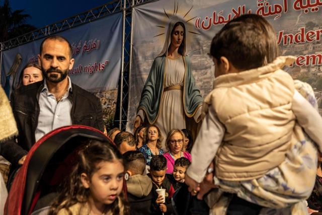 Palestinian Catholic faithfuls gather during the Marian Festival, which honors the Virgin Mary, in the Israeli-occupied West Bank village of Taybeh on May 29, 2026. At least 1,073 Palestinians, including several armed fighters, have been killed by Israeli soldiers or settlers in the West Bank since the outbreak of the Gaza war following Hamas's attack on 7 October 2023, according to an AFP tally based on Palestinian Authority data. On the other hand, official Israeli data shows at least 46 Israelis -- civilians and soldiers -- have been killed in Palestinian attacks or during Israeli military operations in the same period. (Photo by JOHN WESSELS / AFP)