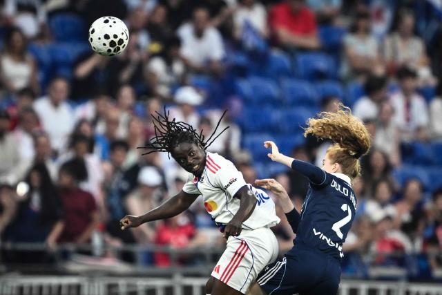 Lyon’s Malawian forward #22 Tabitha Chawinga (L) fights for the ball with Paris FC’s French defender #02 Celina Ould Hocine (R) during the French women L1 football final match between OL Lyonnes and Paris FC at the Groupama stadium in Decines-Charpieu, central-eastern France, on May 29, 2026. (Photo by JEFF PACHOUD / AFP)