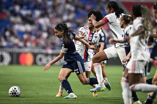 Paris FC’s French forward #10 Clara Mateo (L) fights for the ball with Lyon’s US midfielder #20 Lily Yohannes (R) during the French women L1 football final match between OL Lyonnes and Paris FC at the Groupama stadium in Decines-Charpieu, central-eastern France, on May 29, 2026. (Photo by JEFF PACHOUD / AFP)