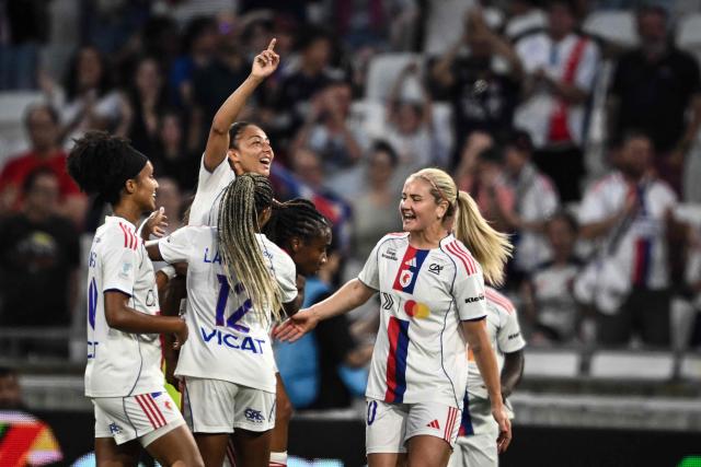 Lyon's players celebrate after Lyon’s Haitian midfielder #06 Melchie Dumornay scored a goal during the French women L1 football final match between OL Lyonnes and Paris FC at the Groupama stadium in Decines-Charpieu, central-eastern France, on May 29, 2026. (Photo by JEFF PACHOUD / AFP)