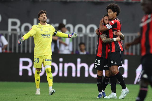 Nice's French defender #92 Jonathan Clauss (2ndR) hugs Nice's Brazilian defender #04 Dante as they celebrate after scoring a first goal during the L1-L2 playoff second-leg football match between first divison club OGC Nice and second division club AS Saint-Etienne at the Allianz Riviera Stadium in Nice, south-eastern France, on May 29, 2026. (Photo by Valery HACHE / AFP)