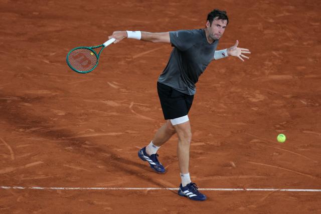 France's Quentin Halys plays a backhand return to Germany's Alexander Zverev during their men's singles match on day 6 of the French Open tennis tournament on Court Philippe-Chatrier at the Roland-Garros Complex in Paris on May 29, 2026. (Photo by Thomas SAMSON / AFP)