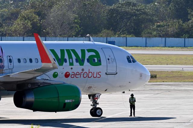 (FILES) A Viva Aerobus plane plane takes taxis at Jose Marti International Airport in Havana on February 9, 2026. Mexican airlines Aeromexico, Viva, and Volaris announced restrictions on flights for passengers arriving from African countries affected by Ebola, effective on May 29, 2026. The restriction applies to travelers entering Mexico by air who have been in Uganda, the Democratic Republic of the Congo, or South Sudan in the past 21 days. (Photo by YAMIL LAGE / AFP)