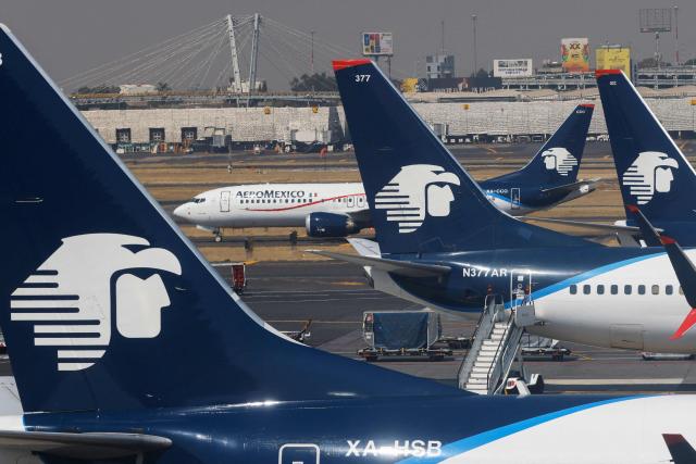 (FILES) Jets of Mexican flag carrier airline Aeromexico are parked at Mexico City's Benito Juarez International Airport on January 30, 2023. Mexican airlines Aeromexico, Viva, and Volaris announced restrictions on flights for passengers arriving from African countries affected by Ebola, effective on May 29, 2026. The restriction applies to travelers entering Mexico by air who have been in Uganda, the Democratic Republic of the Congo, or South Sudan in the past 21 days. (Photo by David GANNON / AFP)