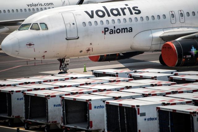 (FILES) A Volaris airline plane sits on the tarmac at the Benito Juarez International airport, in Mexico City, on May 20, 2020, amid the new Covid-19 coronavirus pandemic. Mexican airlines Aeromexico, Viva, and Volaris announced restrictions on flights for passengers arriving from African countries affected by Ebola, effective on May 29, 2026. The restriction applies to travelers entering Mexico by air who have been in Uganda, the Democratic Republic of the Congo, or South Sudan in the past 21 days. (Photo by PEDRO PARDO / AFP)