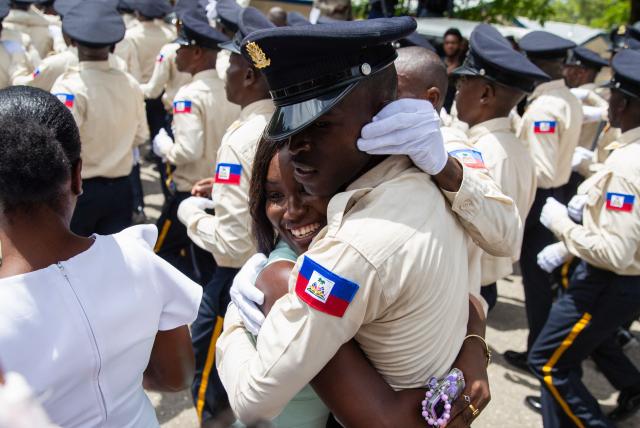 New members of Haiti's National Police celebrate with their relatives at the end of their graduation ceremony at the Police Academy in Port-au-Prince, Haiti, on May 29, 2026. (Photo by Clarens SIFFROY / AFP)