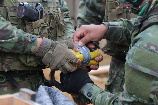 Members of the Army take part in an operation against illegal mining in Buenos Aires, Imbabura province, Ecuador, on May 27, 2026. In Ecuador's rugged La Merced area, soldiers face substantial challenges from illegal gold miners and armed groups, including the Colombian Oliver Sinisterra Front and the Ecuadorian gang Los Lobos. Despite military operations supported by the U.S. to combat mining-related violence, the illegal mining sector continues to thrive, generating over $1.6 billion annually, surpassing drug trafficking revenues in some regions. Recent military efforts include air support and demolitions targeting illegal operations, as the country grapples with high homicide rates and ongoing criminal conflicts fueled by lucrative gold prices. (Photo by Galo Paguay / AFP)