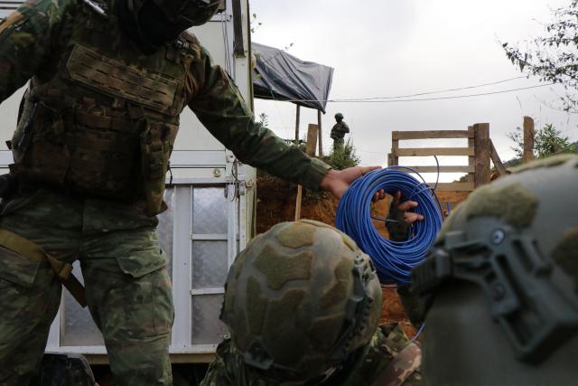 Members of the Army take part in an operation against illegal mining in Buenos Aires, Imbabura province, Ecuador, on May 27, 2026. In Ecuador's rugged La Merced area, soldiers face substantial challenges from illegal gold miners and armed groups, including the Colombian Oliver Sinisterra Front and the Ecuadorian gang Los Lobos. Despite military operations supported by the U.S. to combat mining-related violence, the illegal mining sector continues to thrive, generating over $1.6 billion annually, surpassing drug trafficking revenues in some regions. Recent military efforts include air support and demolitions targeting illegal operations, as the country grapples with high homicide rates and ongoing criminal conflicts fueled by lucrative gold prices. (Photo by Galo Paguay / AFP)