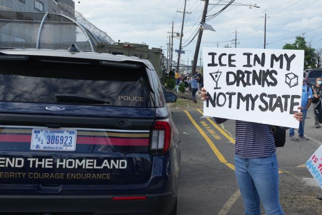 A protester stands outside the federal immigration center at Delaney Hall, which is being used as an Immigration and Customs Enforcement (ICE) detention center, in Newark, New Jersey, on May 29, 2026. Protesters clashed with US law enforcement outside an immigration detention center in New Jersey, a top US official said Friday, after inmates inside staged a hunger strike over conditions. Days of unrest outside the ICE detention center have led to several arrests as a tough stance by US President Donald Trump's administration draws stiff opposition. (Photo by Bryan R. SMITH / AFP)