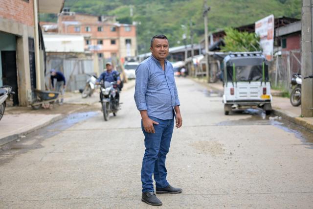 Suarez village mayor Cesar Lizardo Ceron poses por a photo on a street in Suarez, Cauca department, Colombia on May 27, 2026. Surrounded by Andean mountains shrouded in clouds and tropical vegetation, Suarez is a rural village in the Cauca department located near a military base that is constantly under attack by dissident groups that broke away from the 2016 peace agreement with the now-defunct FARC guerrilla group. Locals will elect the successor to President Gustavo Petro on May 31, 2026, the first left-wing leader in the country's history who unsuccessfully attempted to negotiate peace with armed groups. (Photo by Joaquín SARMIENTO / AFP)
