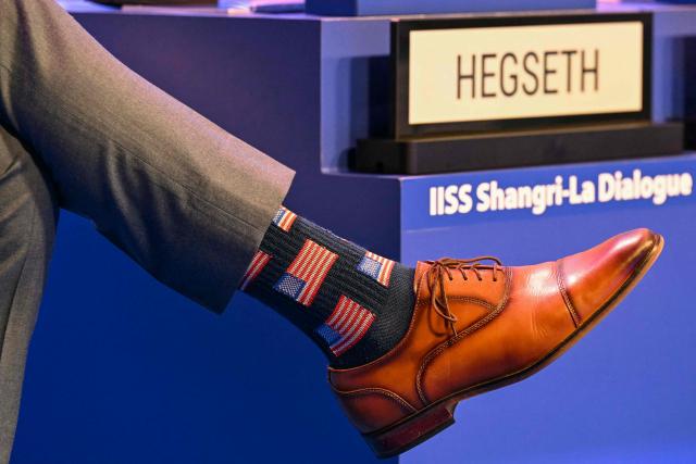 Socks featuring United States flag prints worn by US Secretary of Defence Pete Hegseth are seen during a plenary session of the 23rd Shangri-La Dialogue summit in Singapore on May 30, 2026. (Photo by JAM STA ROSA / AFP)