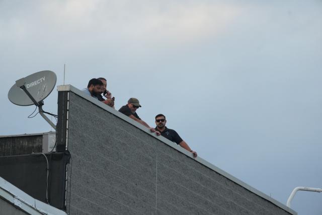 Agents surveil from the roof at the federal immigration center at Delaney Hall, which is being used as an Immigration and Customs Enforcement (ICE) detention center, in Newark, New Jersey, on May 29, 2026. According to US media reports, demonstrators clashed with federal agents over the holiday weekend over alledged poor living conditions inside the detention facility. (Photo by Bryan R. SMITH / AFP)