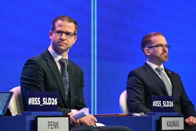 New Zealand's Defence Minister Chris Penk (L) and Lithuania's Defence Minister Robertas Kaunas attend a plenary session of the 23rd Shangri-La Dialogue summit in Singapore on May 30, 2026. (Photo by JAM STA ROSA / AFP)