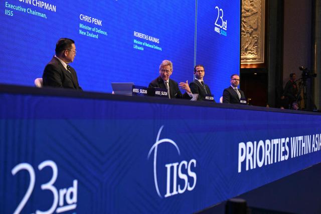 (L-R) Association of Southeast Asian Nations (ASEAN) Secretary General Kao Kim Hourn, Executive Chairman of The International Institute for Strategic Studies (IISS) John Chipman, New Zealand's Defence Minister Chris Penk, and Lithuania's Defence Minister Robertas Kaunas attend a plenary session of the 23rd Shangri-La Dialogue summit in Singapore on May 30, 2026. (Photo by JAM STA ROSA / AFP)