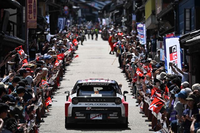 Nikolay Gryazin of Bulgaria and his co-driver Konstantin Aleksandrov of Kyrgyz Republic drive their Lancia Ypsilon HF?on the traditional Japanese townscape of Iwamura during the Rally Japan, the 7th round of the FIA World Rally Championships in Ena city, Gifu prefecture on May 30, 2026. (Photo by Toshifumi KITAMURA / AFP)