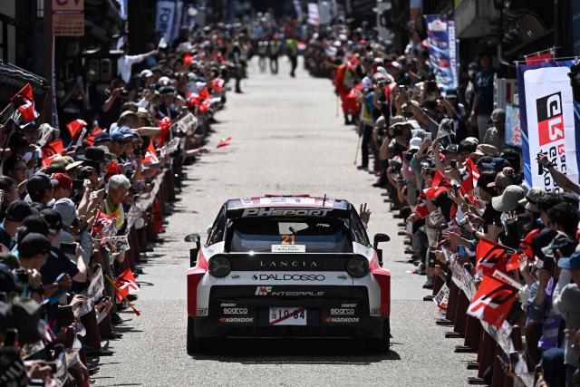 Nikolay Gryazin of Bulgaria and his co-driver Konstantin Aleksandrov of Kyrgyz Republic drive their Lancia Ypsilon HF?on the traditional Japanese townscape of Iwamura during the Rally Japan, the 7th round of the FIA World Rally Championships in Ena city, Gifu prefecture on May 30, 2026. (Photo by Toshifumi KITAMURA / AFP)
