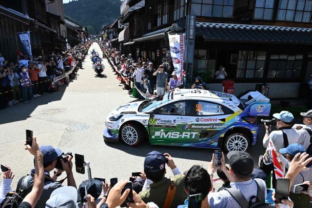 Joshua McErlean of Ireland and his co-driver Eoin Treacy of Ireland drive their Ford Puma Rally1 on the traditional Japanese townscape of Iwamura during the Rally Japan, the 7th round of the FIA World Rally Championships in Ena city, Gifu prefecture on May 30, 2026. (Photo by Toshifumi KITAMURA / AFP)