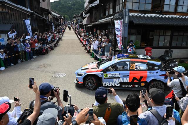 Hayden Paddon of New Zealand and his co-driver John Kennard of New Zealand drive their Hyundai i20 N Rally1 on the traditional Japanese townscape of Iwamura during the Rally Japan, the 7th round of the FIA World Rally Championships in Ena city, Gifu prefecture on May 30, 2026. (Photo by Toshifumi KITAMURA / AFP)