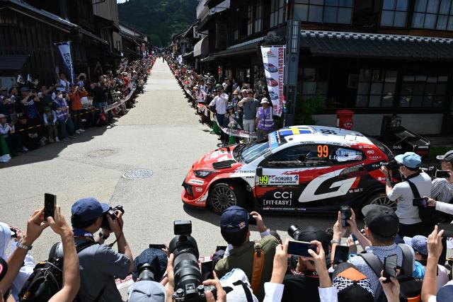 Oliver Solberg of Sweden and his co-driver Elliott Edmondson of Great Britain drive their their Toyota GR Yaris Rally1 on the traditional Japanese townscape of Iwamura during the Rally Japan, the 7th round of the FIA World Rally Championships in Ena city, Gifu prefecture on May 30, 2026. (Photo by Toshifumi KITAMURA / AFP)
