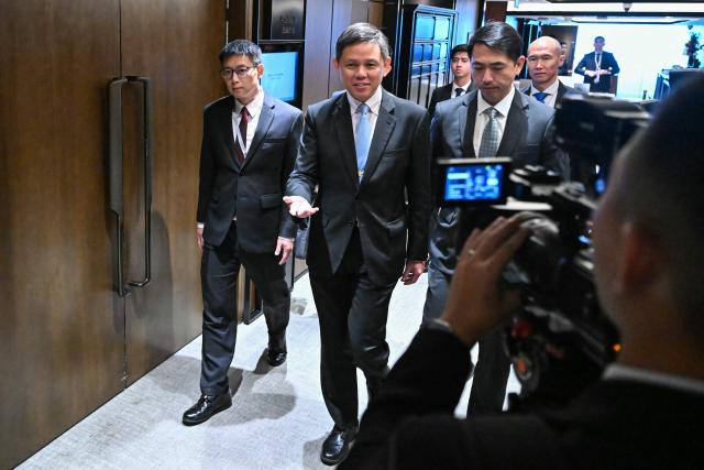 Singapore's Minister of Defence Chan Chun Sing (C) arrives for a ministerial roundtable during the 23rd Shangri-La Dialogue summit in Singapore on May 30, 2026. (Photo by MOHD RASFAN / AFP)