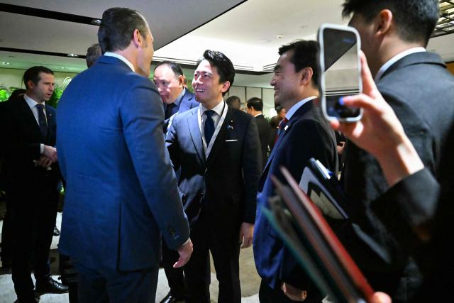 US Secretary of Defence Pete Hegseth (L) speaks with South Korea's Minister of National Defense Ahn Gyu-back (R) and Japan's Defense Minister Shinjiro Koizumi as they arrive for a ministerial roundtable during the 23rd Shangri-La Dialogue summit in Singapore on May 30, 2026. (Photo by MOHD RASFAN / AFP)