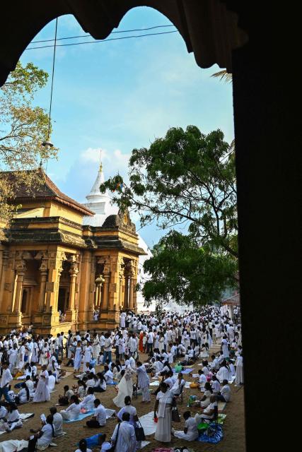 Devotees visit the Kelaniya Buddhist Temple to mark the 'Vesak festival' that commemorates the birth, the enlightenment, and the death of Buddha in Kelaniya on May 30, 2026. (Photo by Ishara S. KODIKARA / AFP)