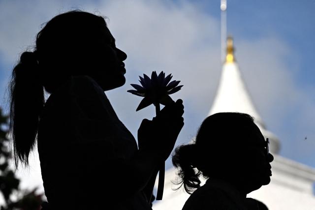 Devotees offer prayers at the Kelaniya Buddhist Temple to mark the 'Vesak festival' that commemorates the birth, the enlightenment, and the death of Buddha in Kelaniya on May 30, 2026. (Photo by Ishara S. KODIKARA / AFP)