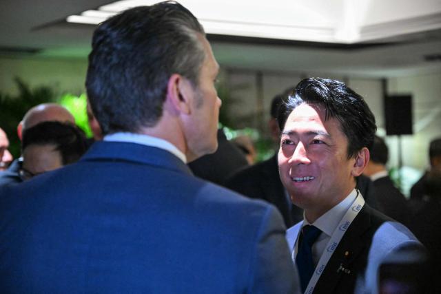US Secretary of Defence Pete Hegseth (L) speaks with Japan's Defense Minister Shinjiro Koizumi as they arrive for a ministerial roundtable during the 23rd Shangri-La Dialogue summit in Singapore on May 30, 2026. (Photo by MOHD RASFAN / AFP)